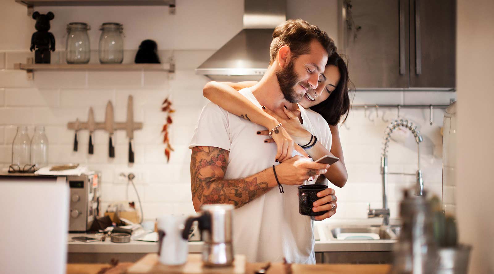 happy couple in their minimalist kitchen
